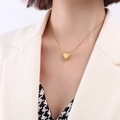 Minimalist 18k gold heart pendant necklace on snake chain shown on model in white blazer - Small / Gold
