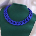 Trendy matte blue chunky acrylic Cuban link necklace displayed on a green mannequin - Matte Style / Blue