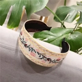Detailed close-up of ethnic floral embroidery on a cream knotted headband with greenery - Standard Type / Vine