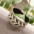 Detail of embroidered green leaves on cream fabric headband with wide knot design - Standard Type / Leaf