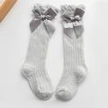 Light grey baby mesh socks featuring ruffle cuffs and large satin bow decorations - Gray