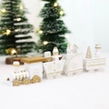 White and gold wooden Christmas train set with four carriages on a snowy surface - White