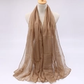 Detail of camel colored candy shade sun protection scarf on mannequin in studio - Khaki