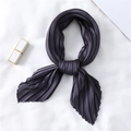 Detail of a charcoal pleated silk scarf in a bow tie knot with smooth satin texture - Dark Gray