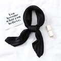 Detailed macro view of black pleated satin neck scarf with elegant silk-like glossy finish - Black