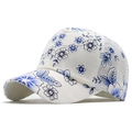 Detailed close-up of breathable white baseball cap with elegant blue floral embroidery - Adjustable / Blue