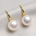 Elegant white freshwater pearl earrings with golden hooks on grey textured fabric - Gold Plated Copper / Standard / Gold White Pearl