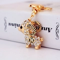 Golden zodiac sheep keychain with white crystals and lobster clasp on white book - White Lamb