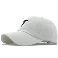 White cotton baseball cap with black pistol embroidery shown from a 45-degree side angle - Adjustable / Double Guns White