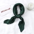 Close-up of deep green pleated satin scarf texture with elegant accordion folds - Dark Green