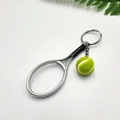 Miniature tennis racket and neon ball keychain set with silver metallic finish - Silver