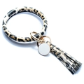 Detail of leopard print PU bangle keychain with gold ring, tassel and round charm - Brown Leopard