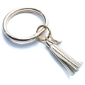Detailed close-up of champagne gold PU leather O-ring keychain with fringe tassel and metal tag - Silver