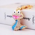 Golden snake keychain with white crystals and blue enamel stripes on white background - Blue Snake