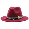 Close-up of wine red wool fedora with turquoise beads, tassels and metal pendant - Burgundy