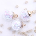 Macro detail of clear glass ball pendant with pink and white star sequins and gold loop - White