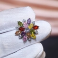 Macro shot of luxury sunflower earrings with multi-color marquise cut cubic zirconia - Colorful