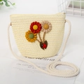 Close-up of beige woven straw kids crossbody bag with fabric sunflowers and ladybug charm - Bag / Milk White