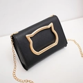 Black crossbody bag featuring a golden cat-head metal ornament and slim gold chain strap - Black