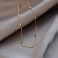 Minimalist gold titanium steel beaded choker necklace on smooth grey satin fabric - Gold (N1009)