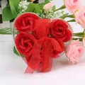 Detailed view of red soap roses in a heart-shaped gift box with a sheer red ribbon bow - Red