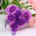 Macro shot of 6 purple heart-shaped rose soap flowers in a clear gift box with bow - Purple