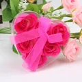 Close-up of heart-shaped gift box with six magenta soap roses and pink ribbon bow decoration - Rose Red
