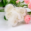 Close-up of 6 white soap roses in a heart-shaped transparent gift box with a white ribbon - White