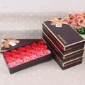 Close-up of 18 red and pink soap roses in a brown gift box with golden Sweet Love ribbon - Red Gradient