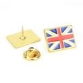Union Jack enamel flag brooch set with gold butterfly clasp and pin back on white background - United Kingdom