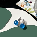 Macro shot of blue square gemstone hoop earrings with micro-pave cubic zirconia on silver - Aquamarine