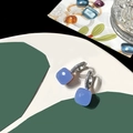Macro view of blue square-cut gemstone earrings with micro-pave zirconia silver settings - Synthetic Blue Jade