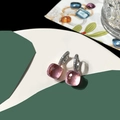 Detail of pink square-cut stone earrings with micro-pave crystals on silver setting - Transparent Pink