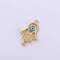 Detailed view of gold Hamsa Hand connector with blue Evil Eye and pavé zircon stones - Green Gold Hamsa Hand