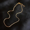 Elegant gold twisted chain necklace displayed on a luxury black silk textured background - Necklace / Gold