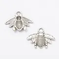 Detailed macro of vintage silver bee charms with intricate wing textures for DIY jewelry - Antique Silver