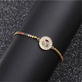 Gold adjustable bracelet featuring a round pendant with multicolored zircon inlay stones - Rainbow Round Heart C
