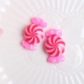 Macro shot of pink resin candy swirl charms for DIY phone cases and craft decoration - Rose Red