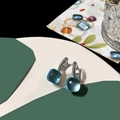 Detail of square light blue crystal earrings with zircon-paved silver setting - Aquamarine