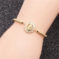Golden beaded bracelet featuring Virgin Mary pendant with cubic zirconia on black background - Gold Bead Chain