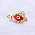 Close-up of gold-plated brass Evil Eye connector with red enamel and white zircon stones - Red Gold Evil Eye