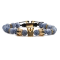 Blue crackle beads bracelet with golden crown charms and black braided cord - Weathered Stone Braided