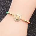 Detail of woven bracelet featuring a gold Virgin Mary charm with pavé cubic zirconia - Multicolor String Style