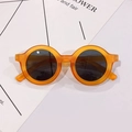 Detail view of round orange kids' sunglasses with matte frames and dark UV lenses - Orange Frame Gray Lens