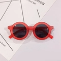 Detail view of round children's glasses with red matte frames and dark circular lenses - Red Frame Gray Lens
