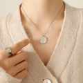 Collar plateado con colgante de concha y perla de agua dulce en una modelo - Color Acero