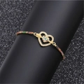 Adjustable gold heart bracelet with colorful cubic zirconia stones on display stand - Heart and Arrow D