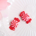 Macro shot of two red and pink resin candy charms for DIY phone case decorations - Red