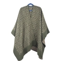 Detail of dark green leopard print knitted poncho cape with elegant tassel fringe finish - Small Leopard Matcha Green