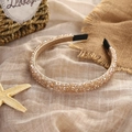 Detail of beaded champagne crystal headband on textured fabric with decorative starfish - Champagne